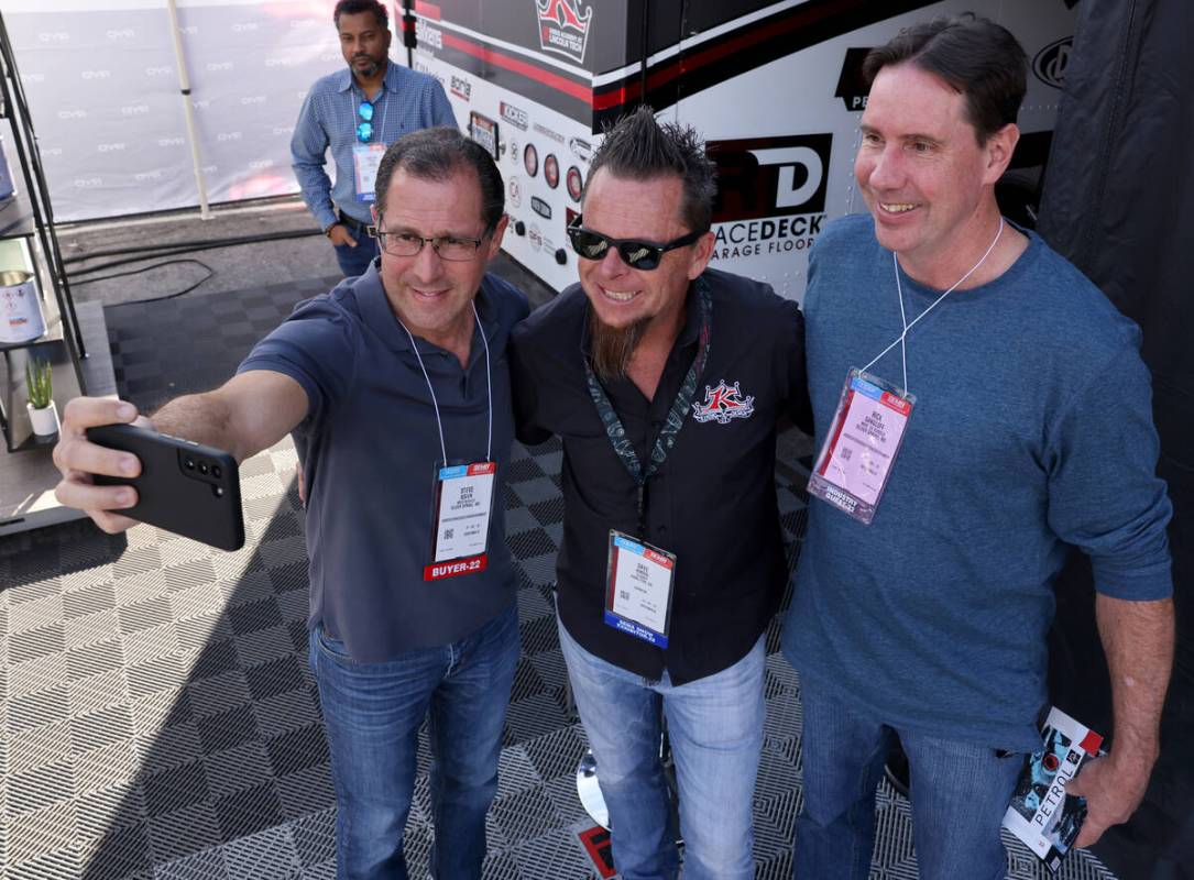 Steve Boden, left, and Rick Gangloff of Silver Spring, Md. pose for a photo with TV personality ...