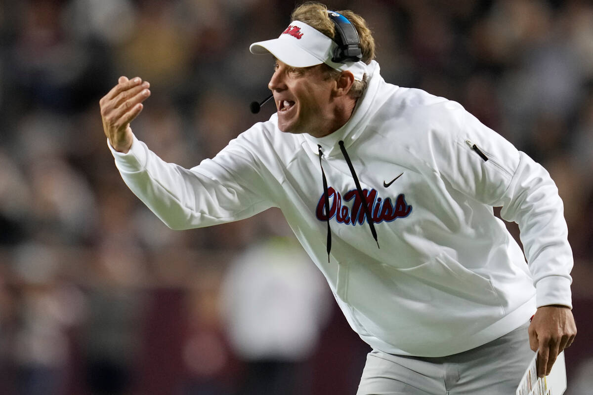 Mississippi head coach Lane Kiffin calls his quarterback over for a talk during the second half ...