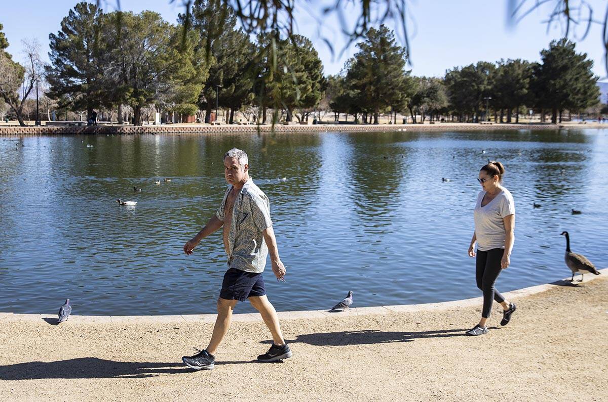 Brian Patterson and his wife Tammy of Las Vegas walk along the pond at Sunset Park on Wednesday ...