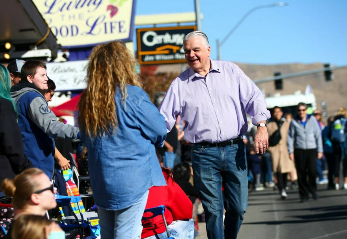 Gov. Steve Sisolak greets visitors during the annual Nevada Day Parade in Carson City on Saturd ...