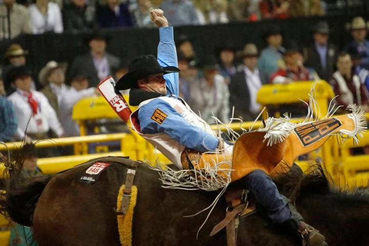 Kaycee Feild, of Genola, Utah, competes in bareback riding during the 2021 Wrangler National Fi ...