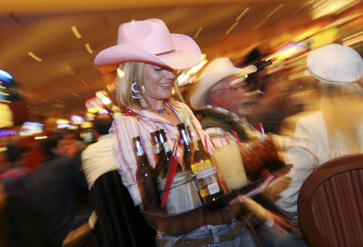 A South Point casino cocktail waitress leaves the room a blur as she rushes to deliver beer and ...