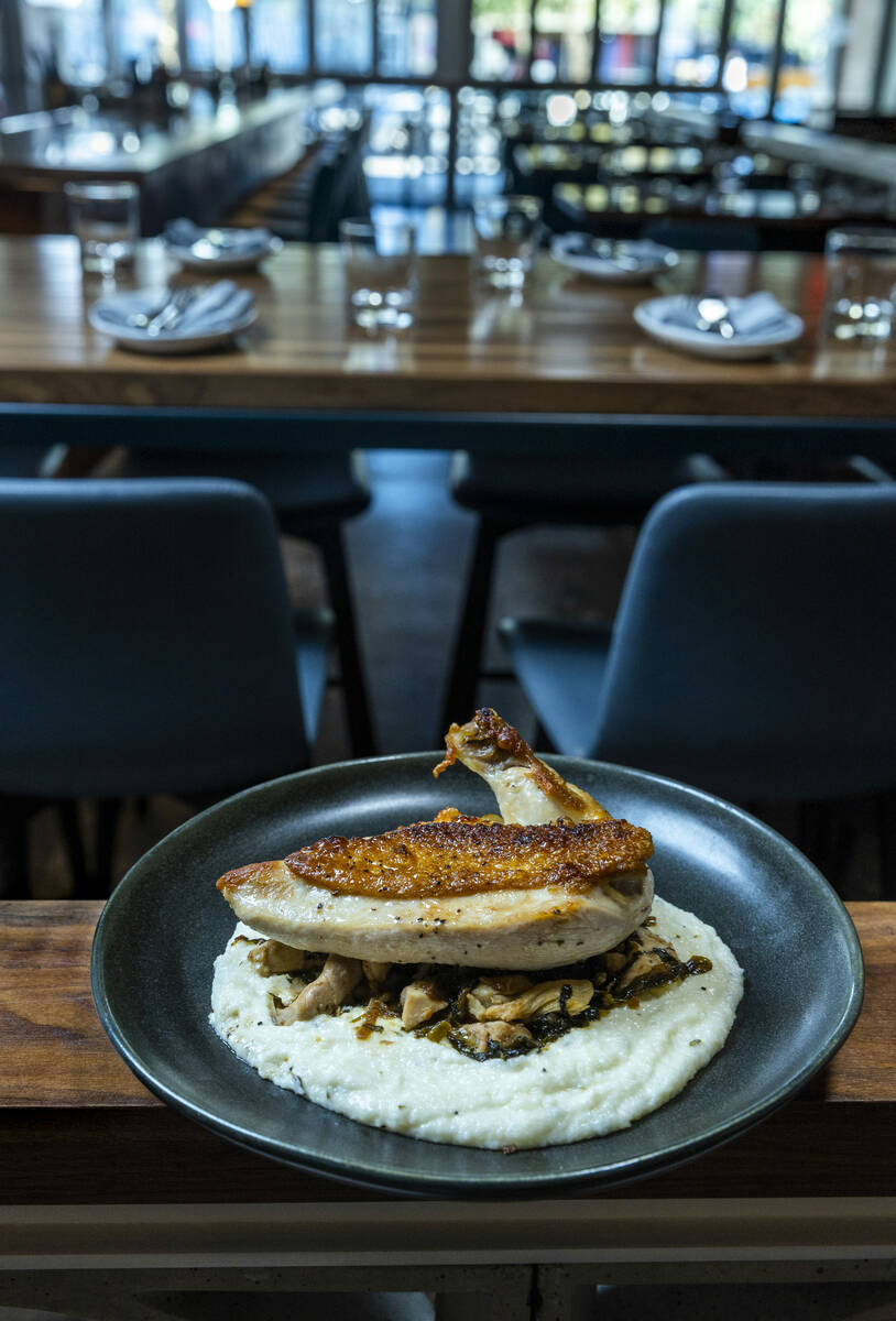 A portion of oven roasted chicken, braised greens and smoked polenta from Main St. Provisions o ...