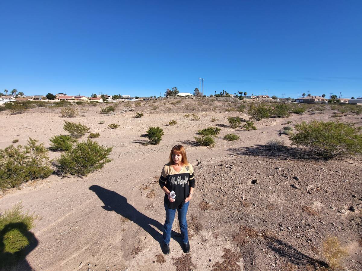 Sharri Warren stands in the lot where the temple will be built. She lives nearby and opposes th ...