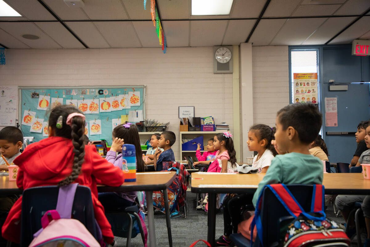 Kindergarten students listen as Jennifer Lopez Romero, not seen, teaches the Spanish half of th ...