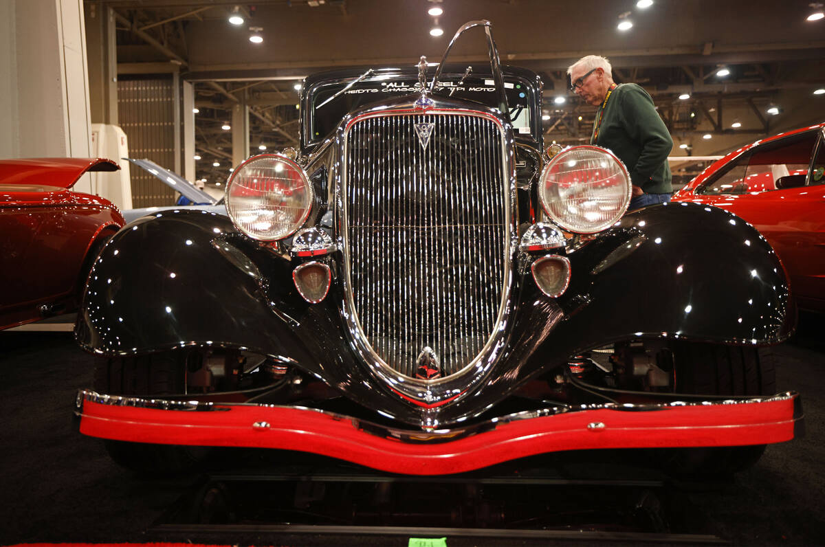 Tom Zink of Oregon checks out a 1934 Ford 5-Window Coupe Street Rod during Mecum Las Vegas auct ...