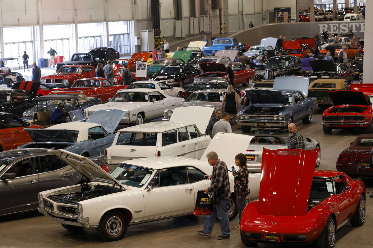 People check out cars during Mecum Las Vegas auction at the Las Vegas Convention Center, Thursd ...