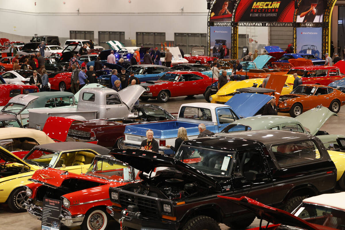 People check out cars during Mecum Las Vegas auction at the Las Vegas Convention Center, Thursd ...