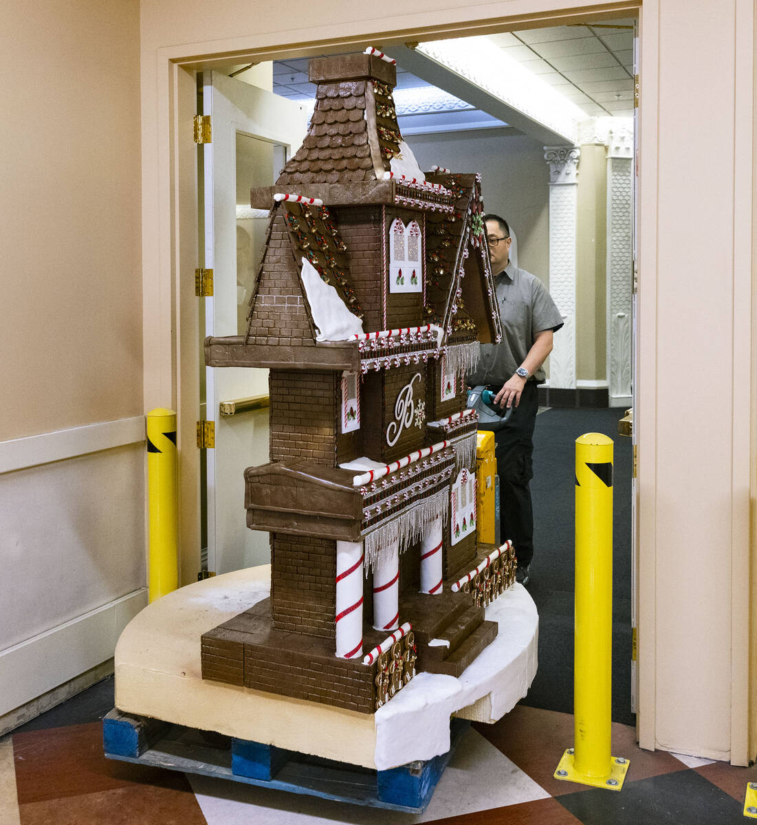 A worker wheels the gingerbread house through the Bellagio kitchen to be displayed in the Bella ...