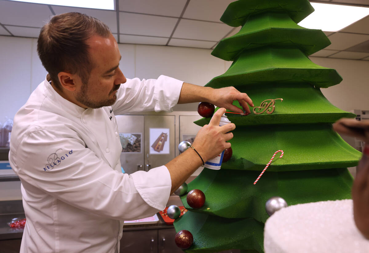 Chef director Philippe Angibeau works on a gingerbread house display at the Bellagio Friday, No ...