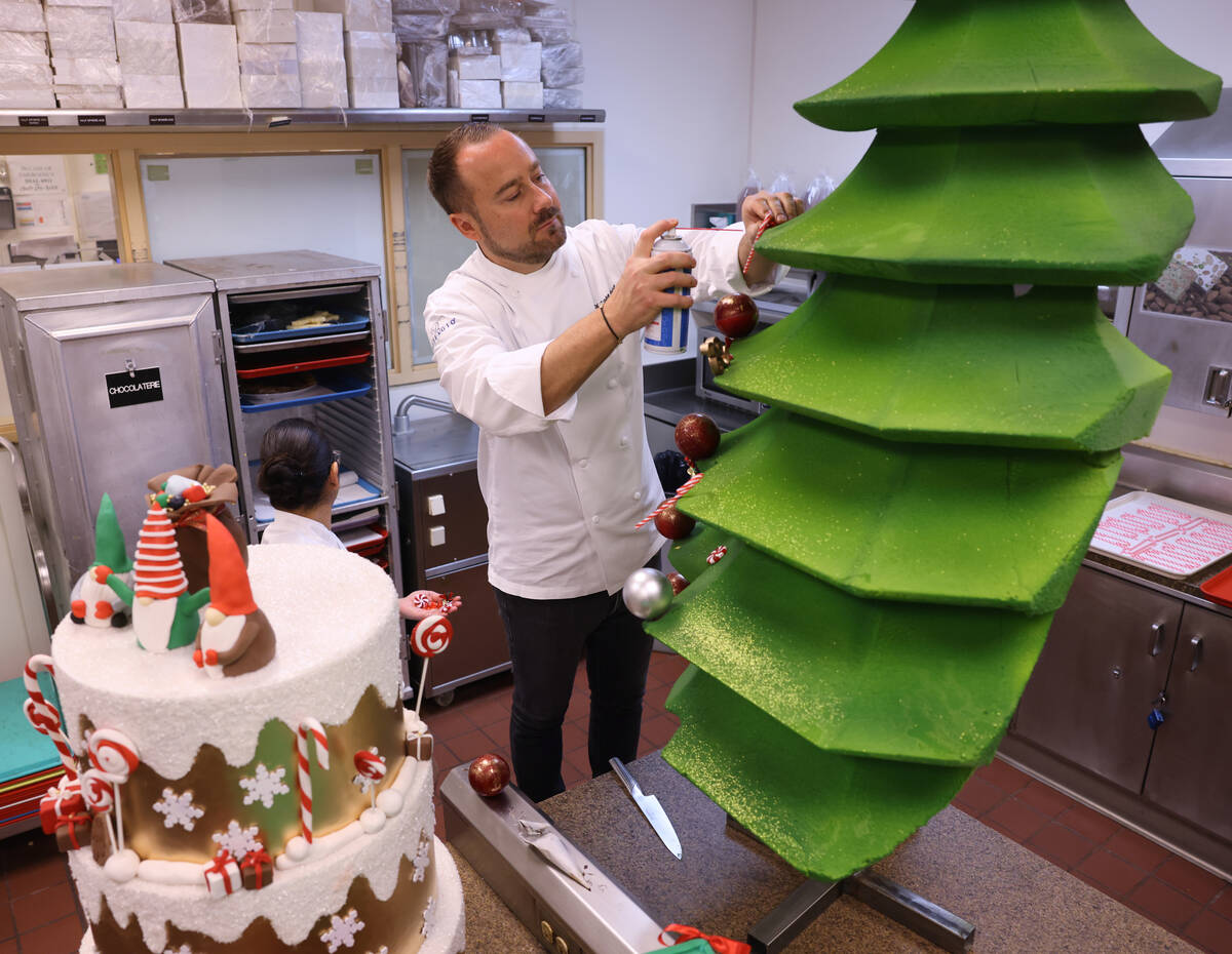 Chef director Philippe Angibeau works on a gingerbread house display at the Bellagio Friday, No ...