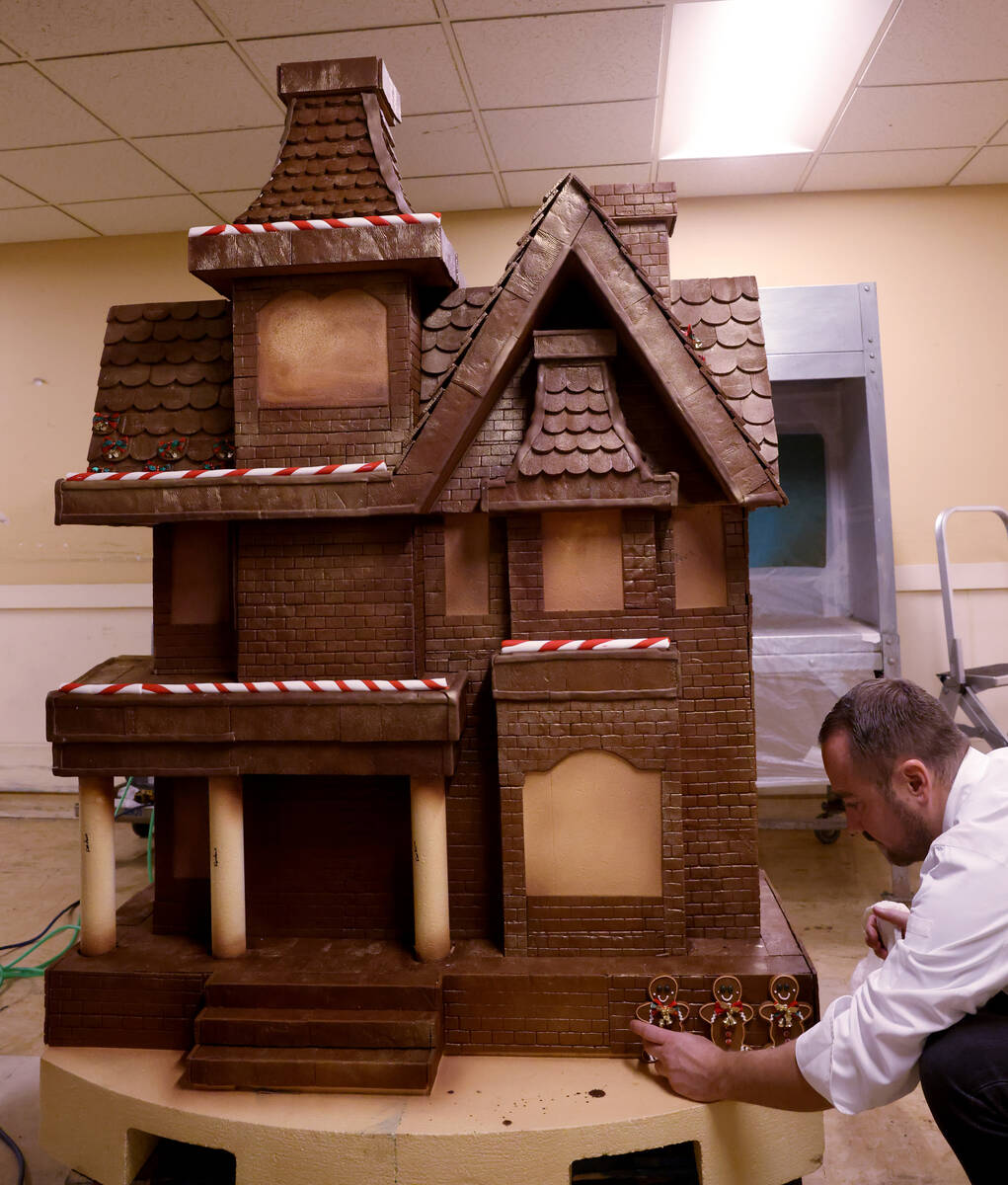 Chef director Philippe Angibeau works on a gingerbread house display at the Bellagio Friday, No ...
