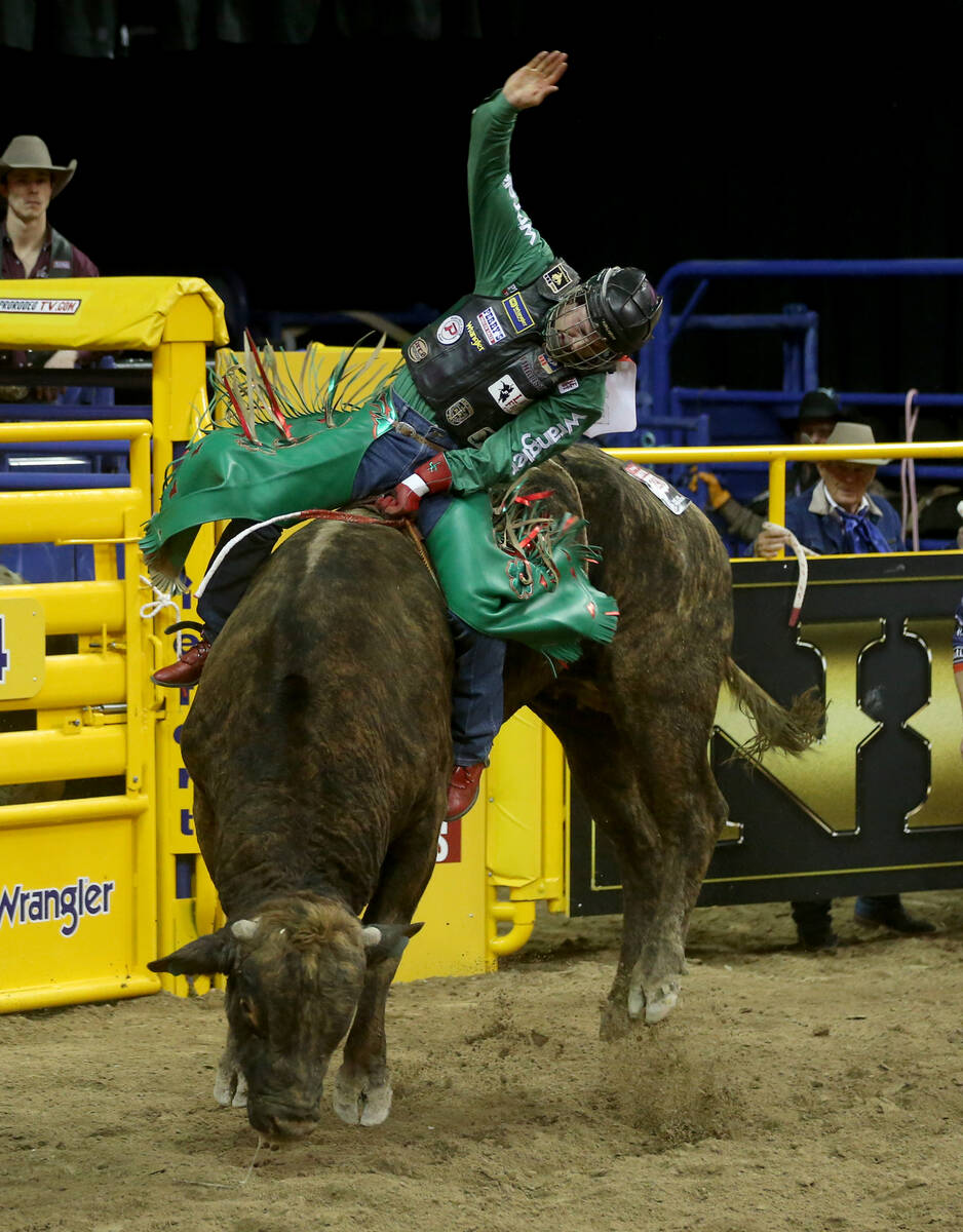 Josh Frost of Radlett, Utah rides Rebeloution in the Bull Riding competition during the first g ...