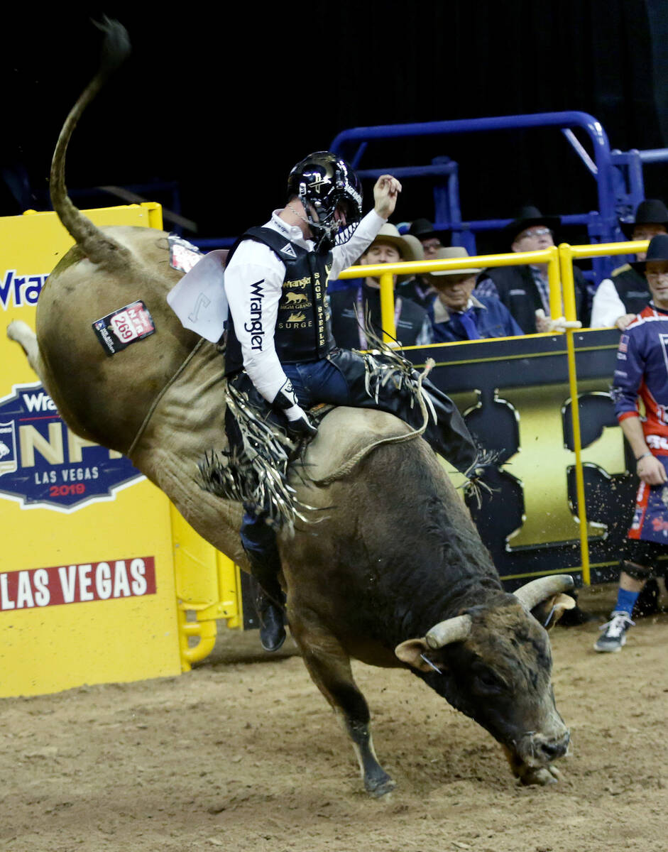 Sage Kimzey of Strong City, Okla. rides SweetPro's Bruiser during Bull Riding in the eighth go ...