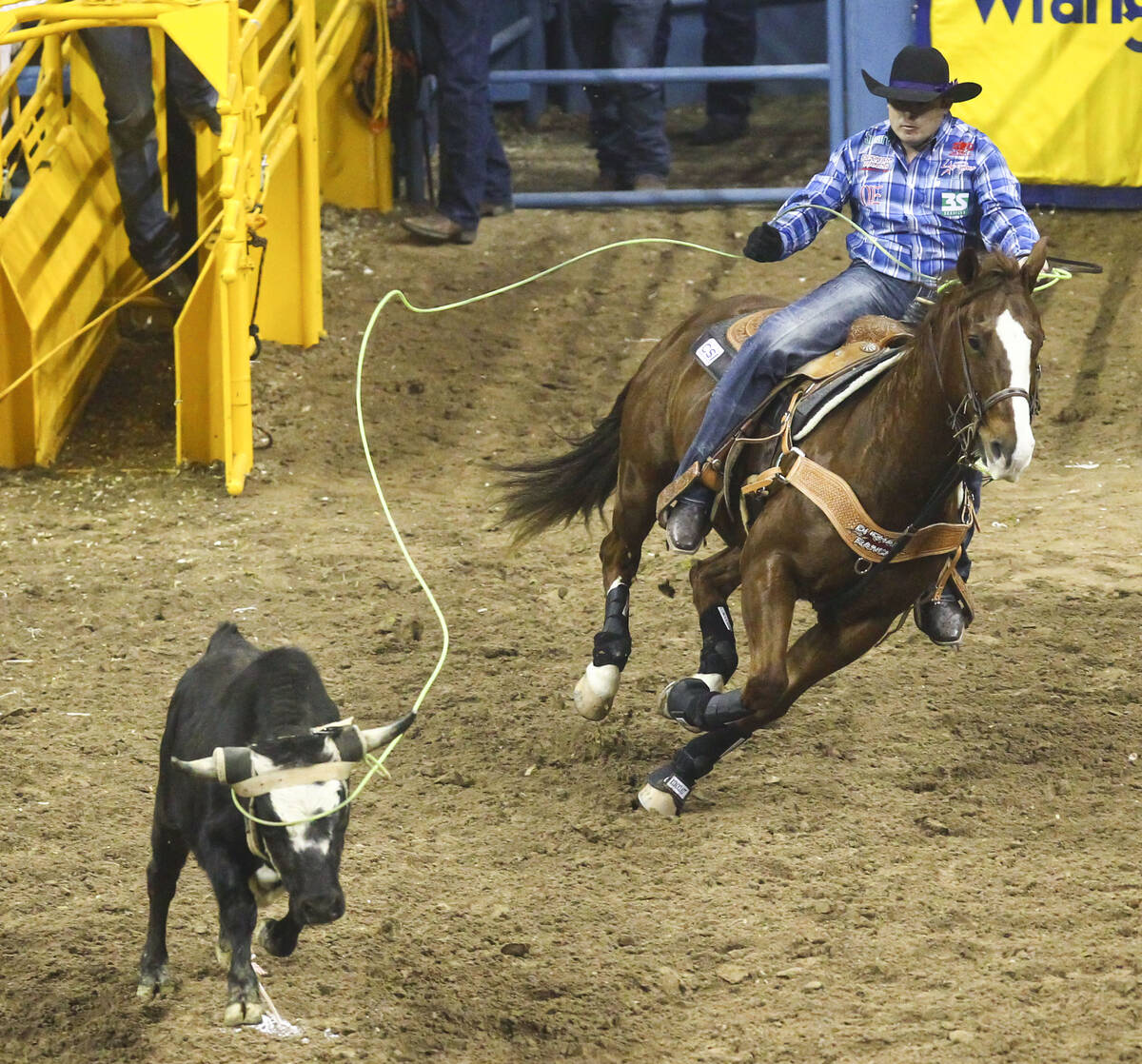 Kaleb Driggers competes in the team roping event during the 3rd go-round of the National Finals ...