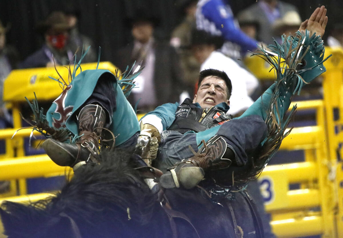 Jess Pope of Waverly, Kan. competes in the bareback riding event during the eighth go-round of ...
