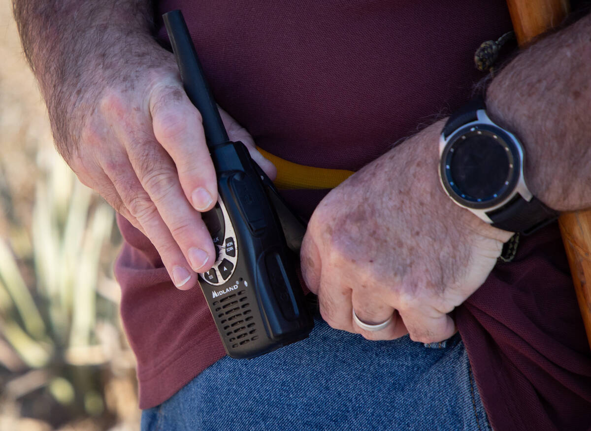 Richard Cumelis, founder of Las Vegas Overweight Hikers for Health, places his walkie-talkie ba ...