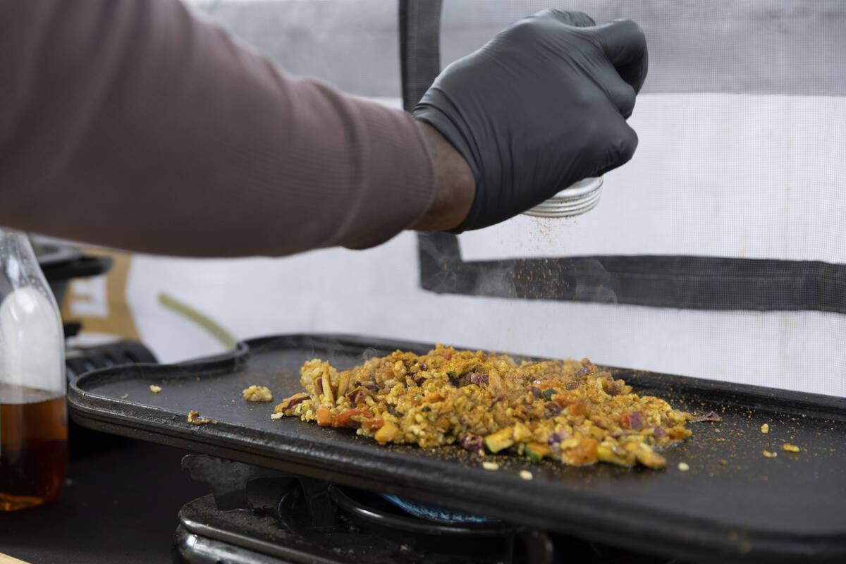 Myles Bunch, owner of a plant-based food business called The Edible Bunch, prepares a curry bur ...