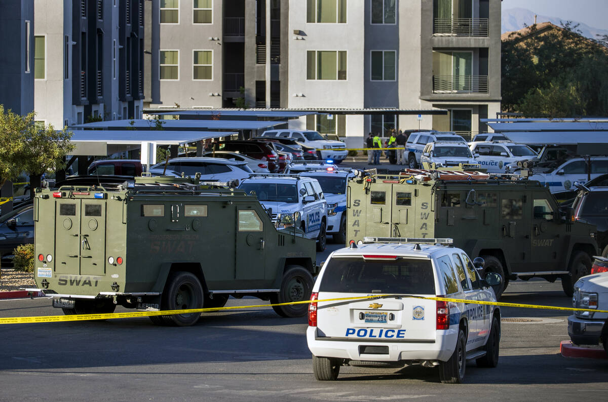 Numerous emergency vehicle as well as SWAT pack the parking lot after four were killed and one ...