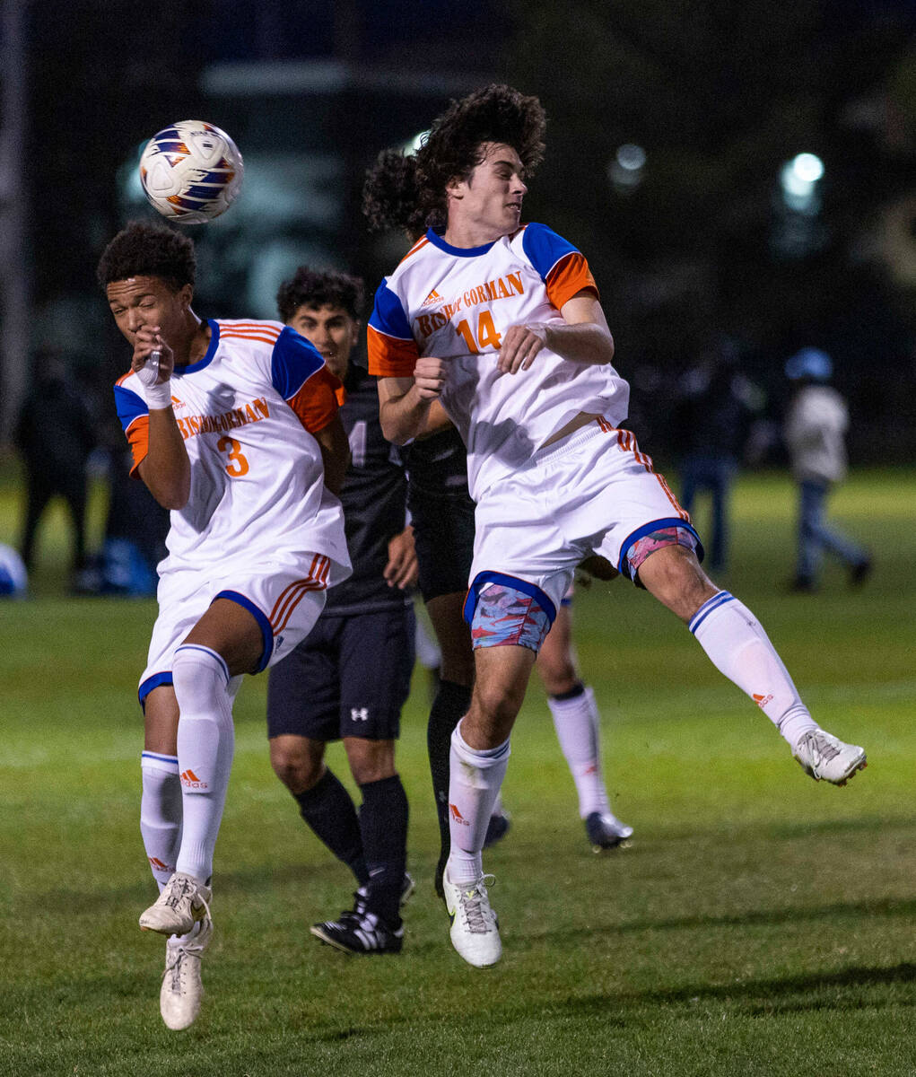 Bishop Gorman's Bronson Rolley (3) and Austin Garlan (14) battle for the ball over Cimarron's d ...