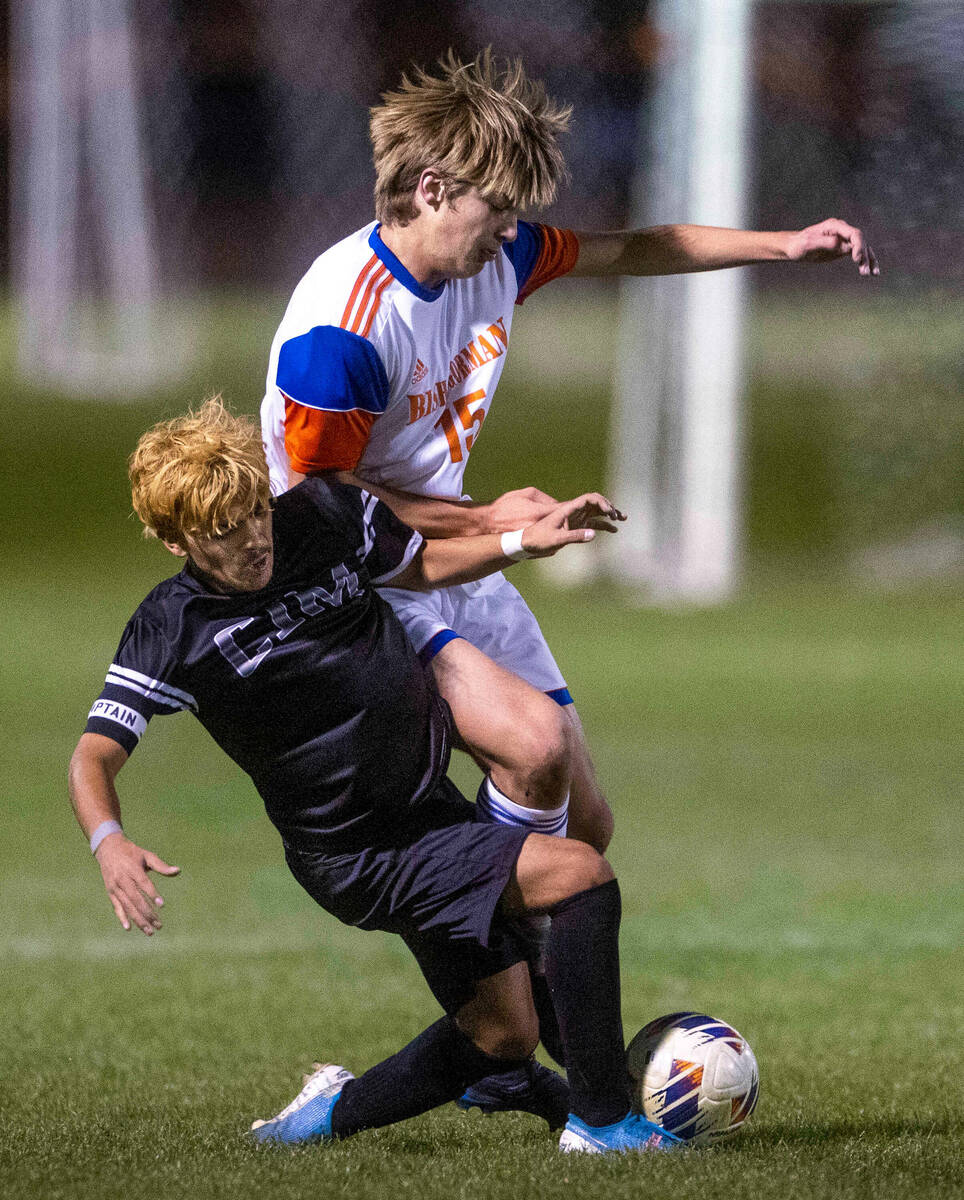 Cimarron's Jecsan Villasenor (10) fights for the ball with Bishop Gorman's Chase Stewart (15) ...