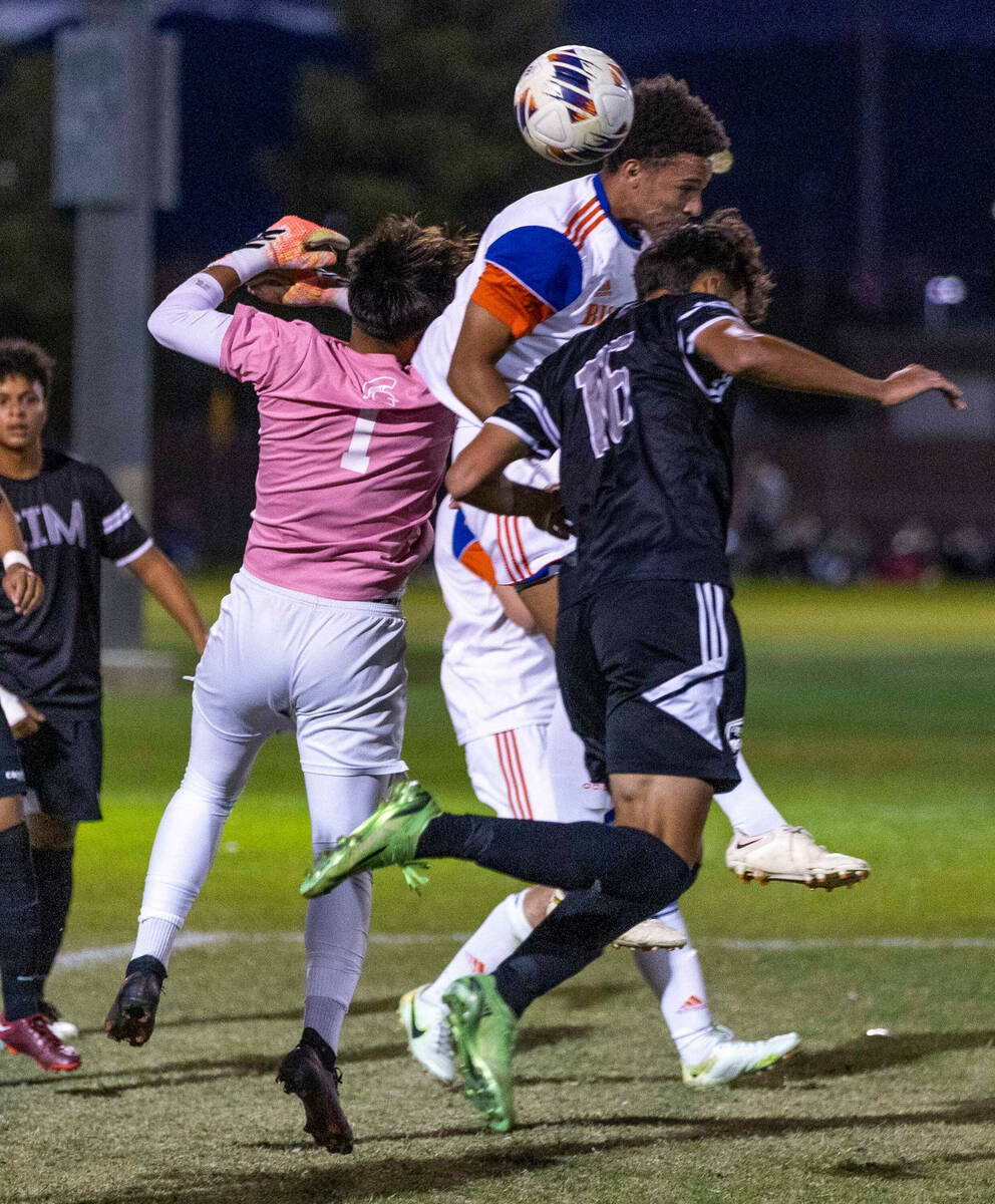 Cimarron's goalie RJ Murillo (1) fights for the ball as Bishop Gorman's Bronson Rolley (3) atte ...