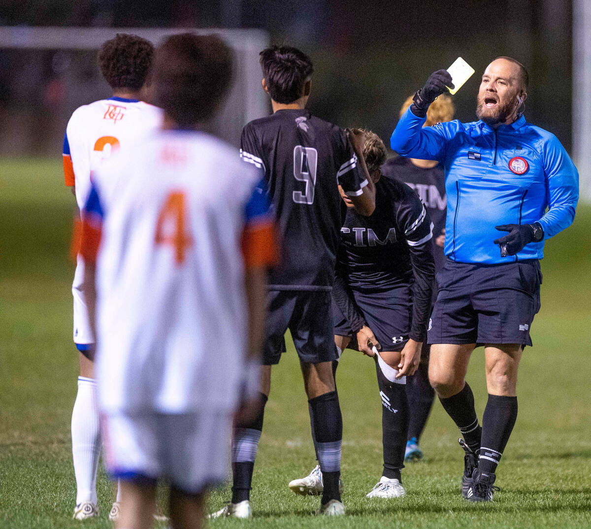 The referee awards a yellow card to Bishop Gorman's Bronson Rolley (3) after tripping Cimarron' ...