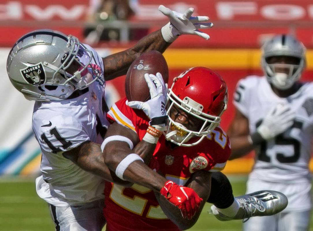 Raiders wide receiver Henry Ruggs III (11) pulls in an acrobatic catch over Kansas City Chiefs ...