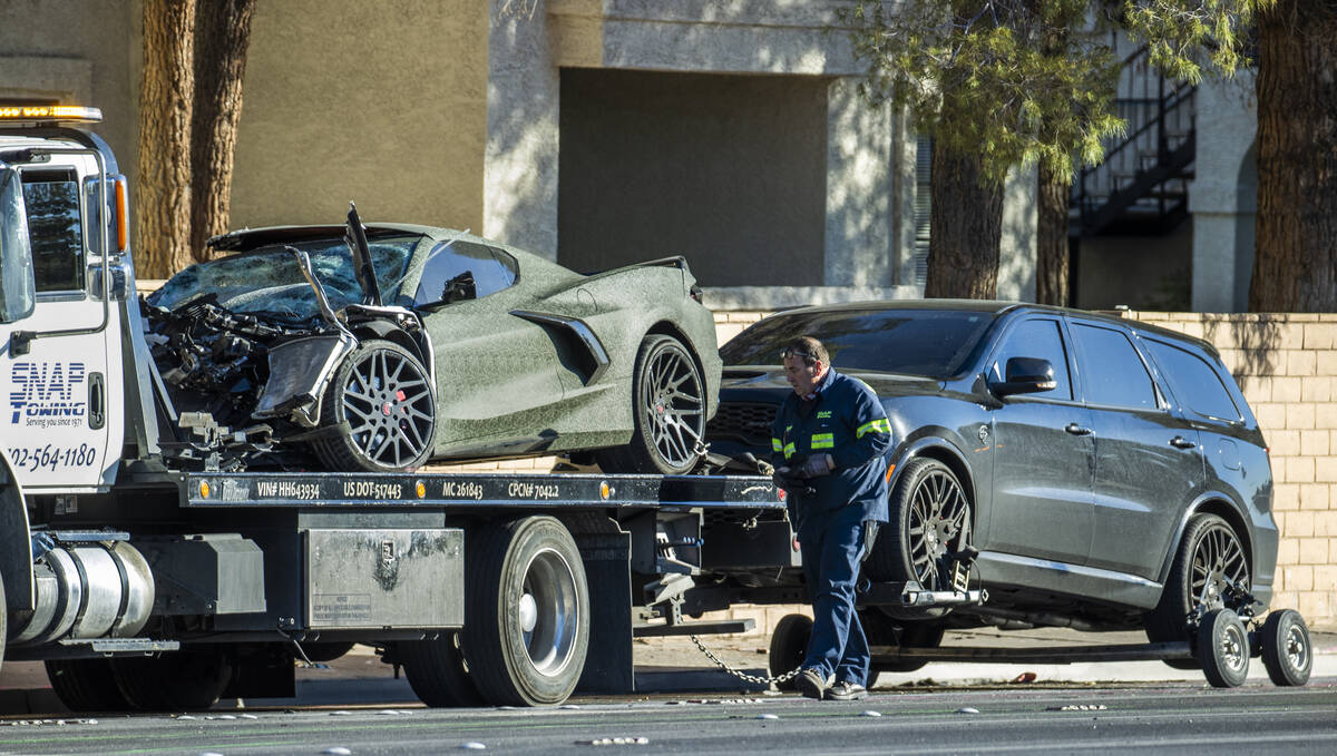 A damaged Corvette driven by Raiders wide receiver Henry Ruggs and Dodge Durango are loaded for ...
