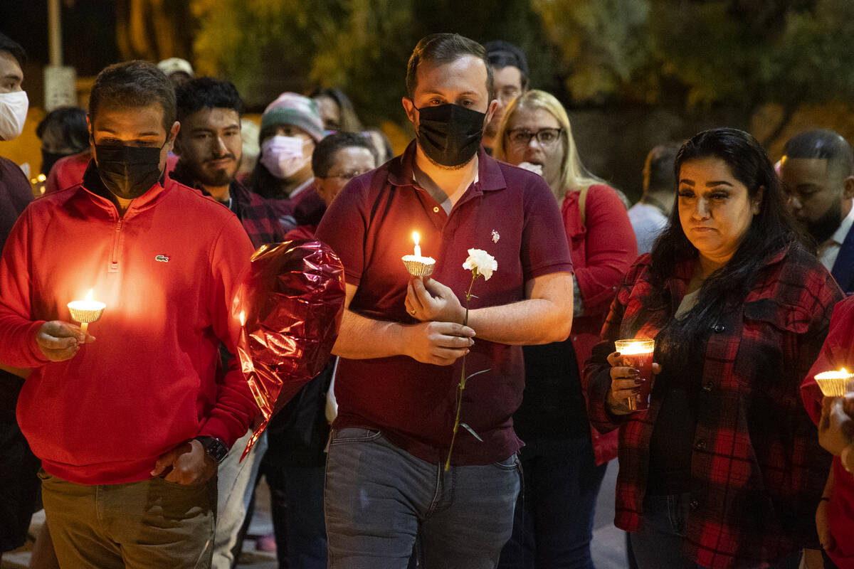 Heitor Gomes, from left, Patrick Lafleur and Rachel Gattis, attend a vigil for their coworker T ...