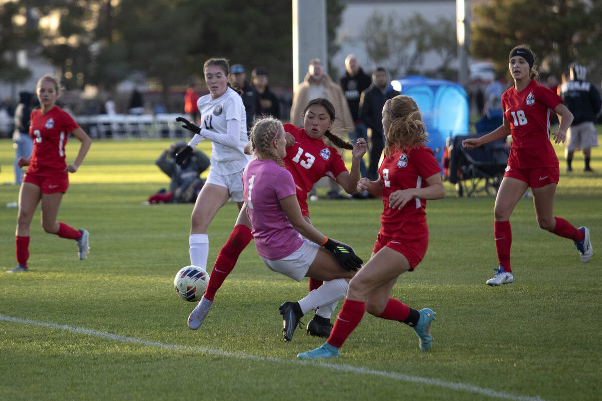 Coronado’s Asia Moises (13) and Elle Bachhuber (2) attempt to score a goal past Desert O ...
