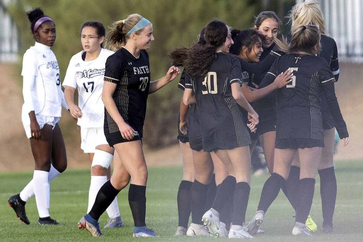 Faith Lutheran gathers to celebrate after scoring a goal during a Class 5A girls soccer regiona ...