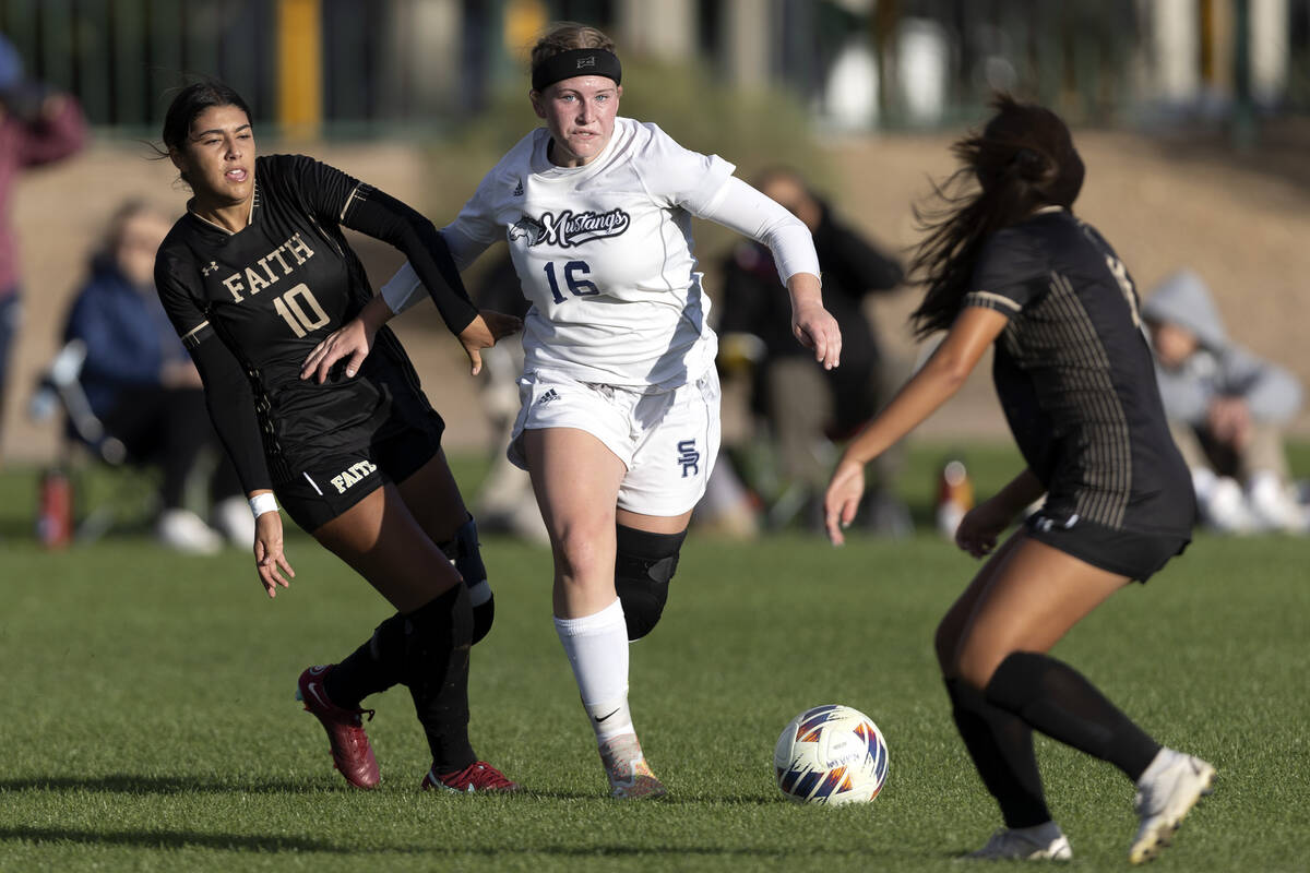 Shadow Ridge’s Meghan Wilhite (16) dribbles against Faith Lutheran’s Andrea Levya ...