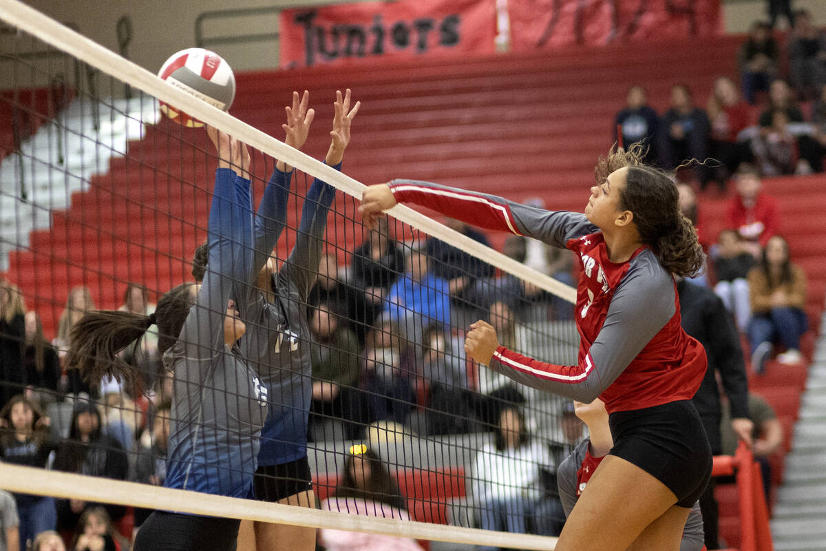 Arbor View’s Willow Watson spikes to Basic’s Martina Moro, left, and Annamarie Ra ...