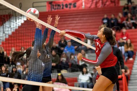 Arbor View’s Willow Watson spikes to Basic’s Martina Moro, left, and Annamarie Ra ...
