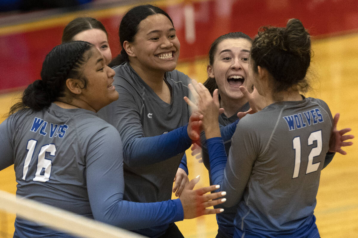 Basic gathers to celebrate a point during a Class 4A girls state volleyball quarterfinal game a ...