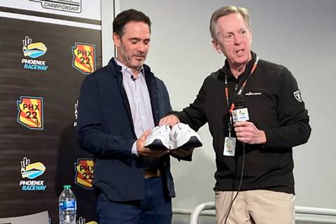 Maury Gallagher, right, presents Jimmie Johnson with “official team owner shoes” ...