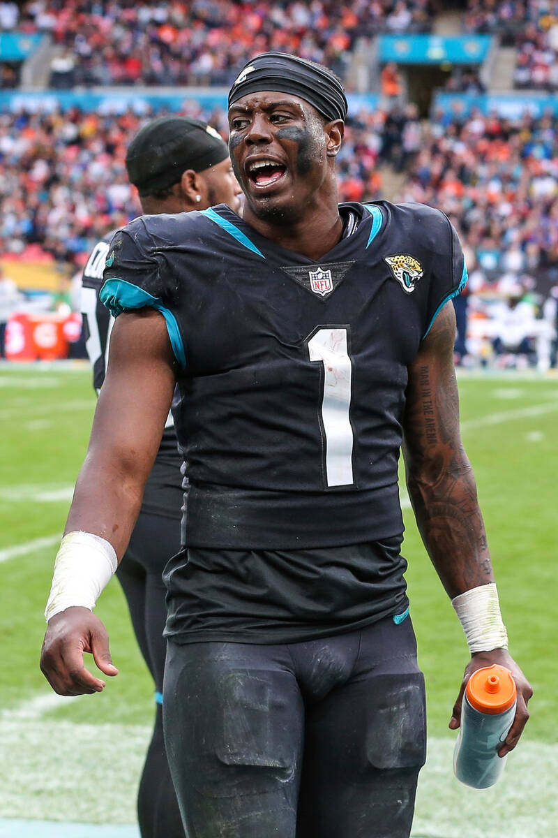 Jacksonville Jaguars running back Travis Etienne Jr. (1) talks to teammates on the sideline dur ...