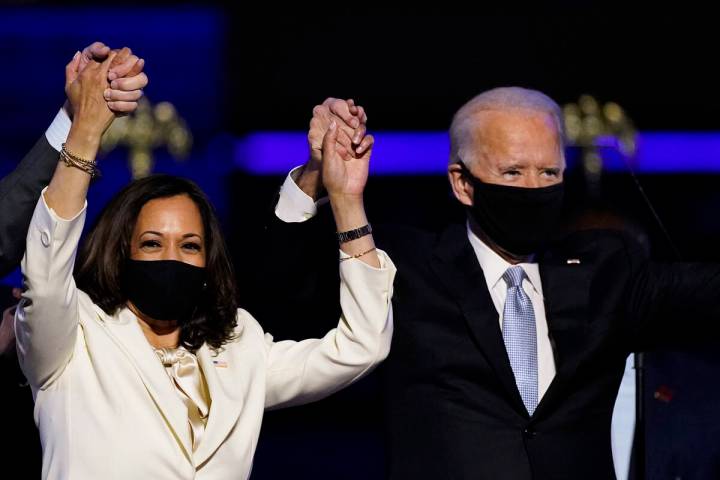 FILE - In this Nov. 7, 2020, file photo Vice President-elect Kamala Harris holds hands with Pre ...