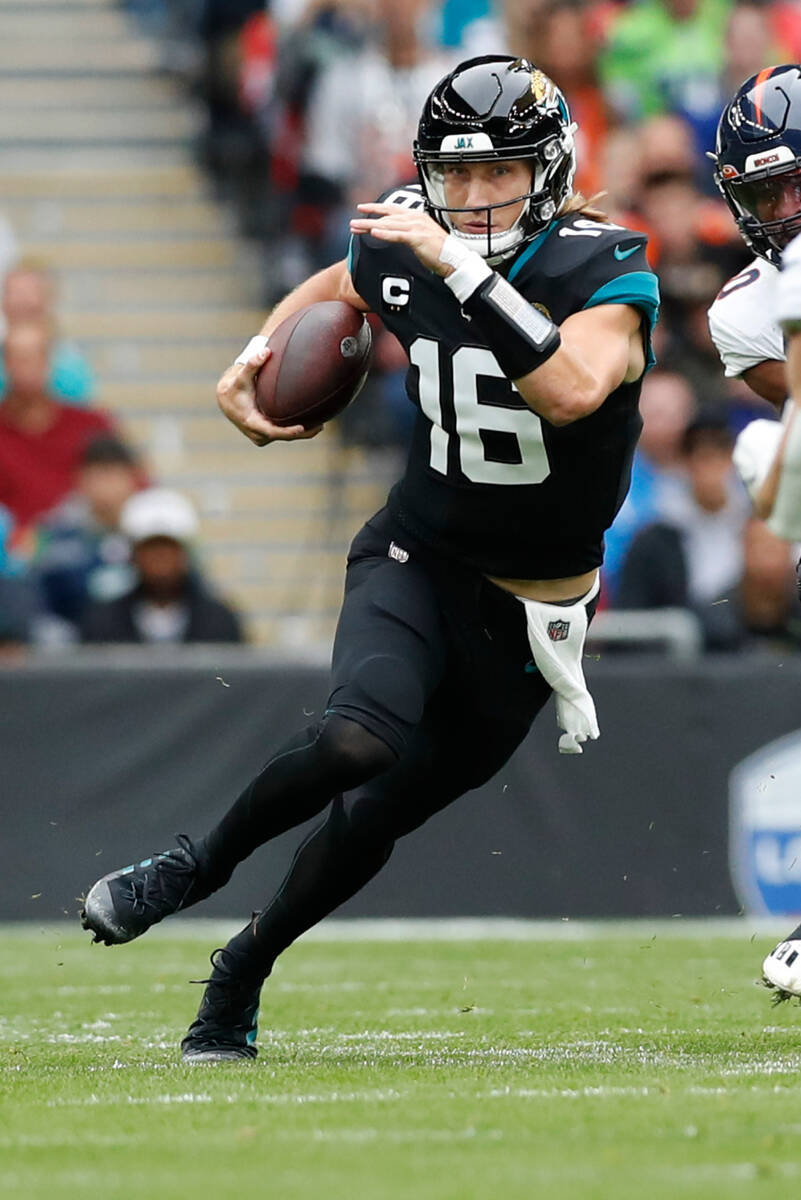 Jacksonville Jaguars quarterback Trevor Lawrence (16) runs the ball during an NFL football game ...