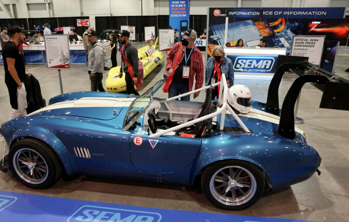 Michael and Nadine Skougard of Pueblo, Colo. check out an all electric AC Cobra based on the 19 ...