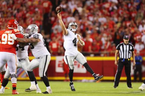 Raiders quarterback Derek Carr (4) throws a pass to Raiders wide receiver Davante Adams (17) fo ...