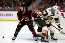 Ottawa Senators defenseman Erik Brannstrom (26) puts himself between the puck and Vegas Golden ...