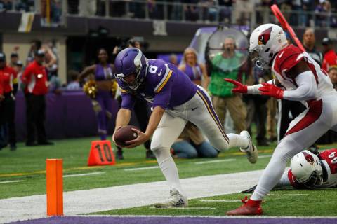Minnesota Vikings quarterback Kirk Cousins (8) scores on a 17-yard touchdown run ahead of Arizo ...