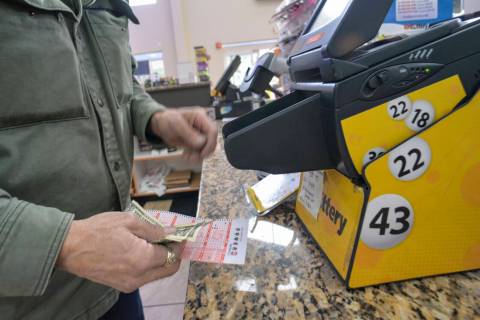 Bruce Gideos, floor manager at Pierre's Place, in Chesterfield, N.H., prints out Powerball tick ...