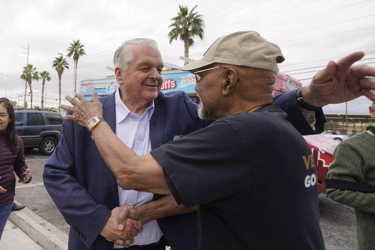 Nevada Gov. Steve Sisolak, left, embraces Willie L. Smith during a campaign event Tuesday, Nov. ...