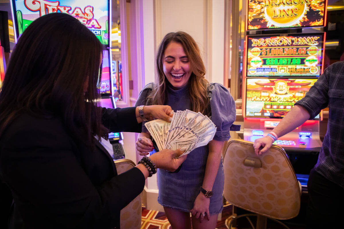 Isidra Randal, an employee at the Venetian Casino, pays out Francine Maric before she starts to ...