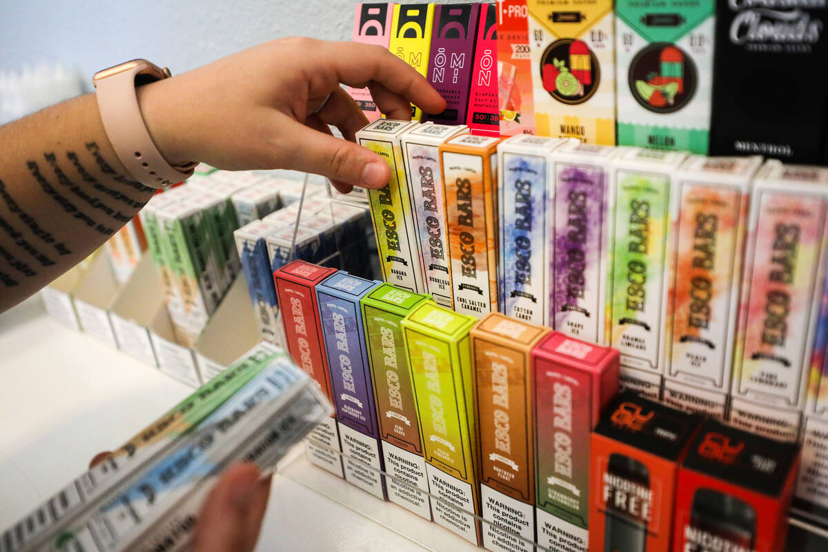 Marketing Manager Nicole Whelan reorganizes disposable vape pens at Vapeco in Las Vegas, Thursd ...