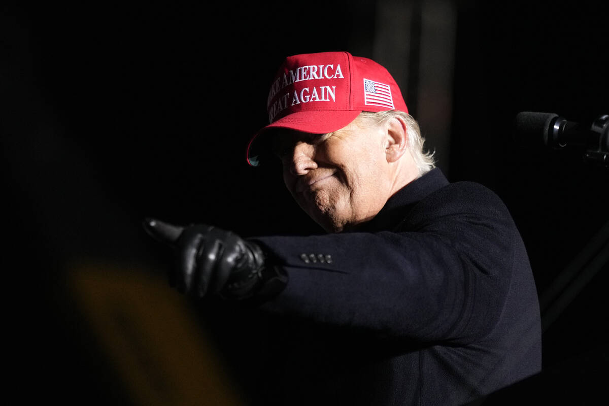 Former President Donald Trump reacts to a supporter during a rally, Thursday, Nov. 3, 2022, in ...
