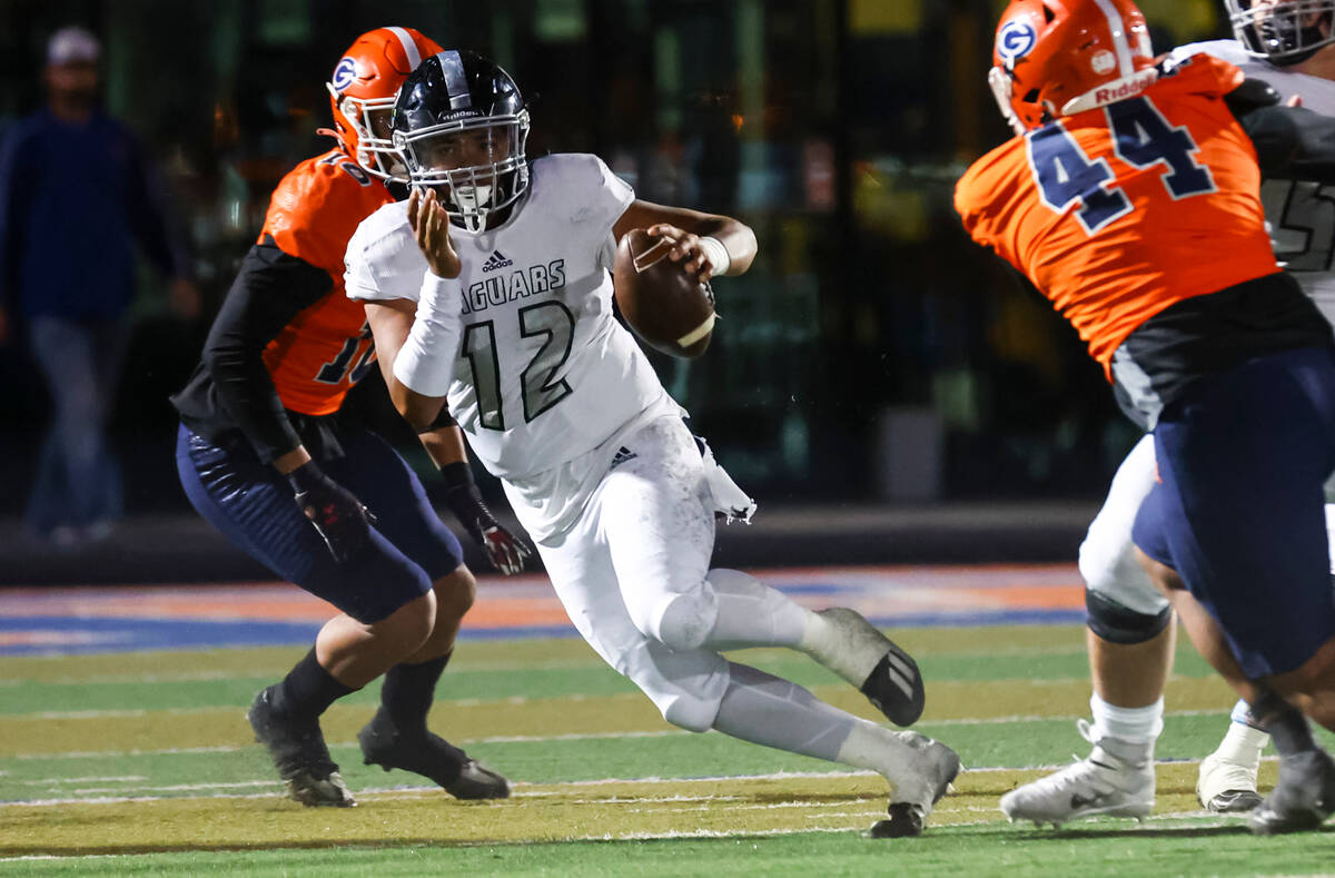 Desert Pines’ AJ Stowers (12) runs the ball during the first half of the Class 5A playof ...